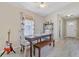 Light-filled dining room with a wooden table, bench seating, and stylish decor at 1224 Decoy Ct, Mount Pleasant, SC 29464