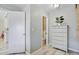Hallway with a view of the bathroom, bedroom, wood-look floors, and a painted white chest of drawers at 1224 Decoy Ct, Mount Pleasant, SC 29464