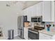 Well-lit kitchen boasts stainless steel appliances and white cabinetry at 1224 Decoy Ct, Mount Pleasant, SC 29464
