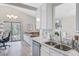 Modern kitchen with marble countertops, stainless steel appliances, and an open view to the living room at 1224 Decoy Ct, Mount Pleasant, SC 29464
