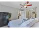 A main bedroom with a ceiling fan, a Liberty Safe, an ensuite bathroom, and wood-look flooring for a modern look at 1224 Decoy Ct, Mount Pleasant, SC 29464