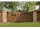 Wooden fence with brick pillars and iron decor in a manicured backyard at 1228 Penny Cir, Mount Pleasant, SC 29464
