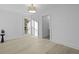Well-lit bedroom showcasing light hardwood floors, a modern light fixture, and an ensuite bathroom at 1228 Penny Cir, Mount Pleasant, SC 29464