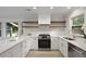 Modern kitchen with white cabinets, stainless appliances, and marbled countertops at 1228 Penny Cir, Mount Pleasant, SC 29464