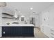 Modern white kitchen features dark island, stainless steel appliances, and open shelving at 1228 Penny Cir, Mount Pleasant, SC 29464