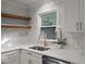 Bright kitchen features stainless sink, white marbled countertops, and floating shelves at 1228 Penny Cir, Mount Pleasant, SC 29464