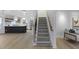 Bright living room with staircase view to kitchen with dark island and stainless appliances at 1228 Penny Cir, Mount Pleasant, SC 29464