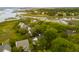 Aerial view of a neighborhood with waterfront access, featuring lush greenery and surrounding waterways at 1483 Harborsun Dr, Charleston, SC 29412