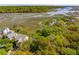 Gorgeous aerial view of upscale homes nestled among lush trees with views of the marsh and channel at 1483 Harborsun Dr, Charleston, SC 29412