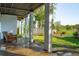 A covered back porch and outdoor chairs provide a relaxing outdoor living space at 1483 Harborsun Dr, Charleston, SC 29412