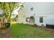 The grassy backyard features mature trees and efficient AC units on elevated platforms at 1483 Harborsun Dr, Charleston, SC 29412