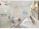 Bright bathroom features a soaking tub, glass shower, double sink vanity, and decorative lighting at 1483 Harborsun Dr, Charleston, SC 29412