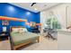bedroom features a large window with a unique blue accent wall and desk at 1483 Harborsun Dr, Charleston, SC 29412