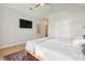 Bright bedroom with a ceiling fan, a TV, light walls, hardwood floors, and a neutral color scheme at 1483 Harborsun Dr, Charleston, SC 29412