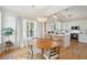 Dining area bathed in natural light from a window and features a modern chandelier at 1483 Harborsun Dr, Charleston, SC 29412