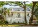Charming two-story home with a classic front porch and lush, mature trees at 1483 Harborsun Dr, Charleston, SC 29412