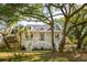 Charming two-story white home with a large front porch and mature trees in a quiet setting at 1483 Harborsun Dr, Charleston, SC 29412