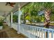 View from a covered porch featuring white columns, wood floors, and a ceiling fan at 1483 Harborsun Dr, Charleston, SC 29412