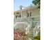 Inviting entrance with a spacious front porch, wooden stairs and decorative lattice at 1483 Harborsun Dr, Charleston, SC 29412