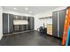 Well-organized garage featuring extensive storage systems, a work bench, and durable flooring for efficient space utilization at 1483 Harborsun Dr, Charleston, SC 29412