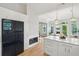 Bright, modern kitchen features white cabinetry, a fireplace, and stainless steel appliances at 1483 Harborsun Dr, Charleston, SC 29412