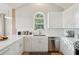 Modern kitchen features stainless steel appliances, white cabinets and countertops, and a stylish window at 1483 Harborsun Dr, Charleston, SC 29412
