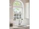 Charming arched window above a stainless steel kitchen sink and white countertops at 1483 Harborsun Dr, Charleston, SC 29412