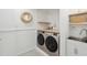 Functional laundry room featuring modern washer/dryer, butcher block countertops and shelving, and a deep utility sink at 1483 Harborsun Dr, Charleston, SC 29412