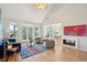 Bright living room with vaulted ceilings, fireplace, and doors leading to a screened in porch at 1483 Harborsun Dr, Charleston, SC 29412