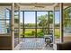 View from screened porch reveals serene marsh landscape with open doors at 1483 Harborsun Dr, Charleston, SC 29412