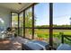 Inviting screened-in porch with comfortable seating and picturesque marsh view at 1483 Harborsun Dr, Charleston, SC 29412