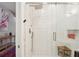 Bright shower with white tile, niche, and a teak bench seat at 1483 Harborsun Dr, Charleston, SC 29412