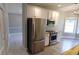 Well-lit kitchen boasting stainless steel appliances, white cabinetry, and a functional layout for easy meal preparation at 15 Muirfield Village Ct, Summerville, SC 29483