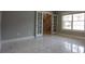 Living room with staircase in view. White tile floor throughout the space at 15 Muirfield Village Ct, Summerville, SC 29483