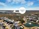 Aerial view showcases the waterfront community dock, pond, and charming residential homes in the neighborhood at 1624 Prince Edward St, Mount Pleasant, SC 29466