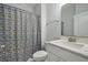 Bright bathroom featuring a white vanity and toilet, complemented by a playful banana-themed shower curtain at 1624 Prince Edward St, Mount Pleasant, SC 29466