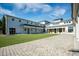 Beautiful courtyard featuring green lawn and a paver patio in front of a light colored building under a sunny, partly cloudy sky at 1624 Prince Edward St, Mount Pleasant, SC 29466