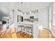 Bright kitchen features stainless appliances, white cabinets, marble countertops and hardwood floors at 1624 Prince Edward St, Mount Pleasant, SC 29466