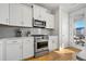 Well-equipped kitchen with stainless steel appliances, white cabinets, and light countertops at 1624 Prince Edward St, Mount Pleasant, SC 29466