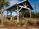 Inviting picnic shelter with wooden beams and picnic tables surrounded by natural grasses at 1624 Prince Edward St, Mount Pleasant, SC 29466