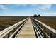 Scenic wooden boardwalk stretching across a marshland landscape with a clear blue sky at 1624 Prince Edward St, Mount Pleasant, SC 29466