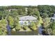 Aerial view of clubhouse and pool bordered by a pond and mature trees in a planned community at 1634 Pin Oak Cut, Mount Pleasant, SC 29466