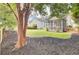 Lush backyard with mature trees, lawn, and screened porch, perfect for outdoor enjoyment at 1634 Pin Oak Cut, Mount Pleasant, SC 29466