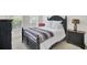 Charming bedroom with dark wood furnishings, a plush bed, and a sunlit window at 1634 Pin Oak Cut, Mount Pleasant, SC 29466