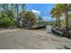 A concrete boat ramp extends into the water surrounded by lush greenery and palm trees at 1634 Pin Oak Cut, Mount Pleasant, SC 29466