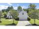 Charming home with a manicured lawn, mature trees, and a welcoming front entrance at 1634 Pin Oak Cut, Mount Pleasant, SC 29466