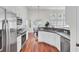 Bright kitchen featuring stainless steel appliances, white cabinetry, and an open layout to the dining area at 1634 Pin Oak Cut, Mount Pleasant, SC 29466