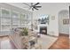 Bright living room with large windows, a fireplace, and built-in shelving at 1634 Pin Oak Cut, Mount Pleasant, SC 29466