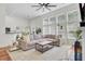 Spacious living room with large windows, comfortable seating, and an open layout to kitchen and dining at 1634 Pin Oak Cut, Mount Pleasant, SC 29466