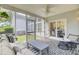 Cozy screened porch features modern furniture, patterned rug, and serene outdoor views at 1634 Pin Oak Cut, Mount Pleasant, SC 29466
